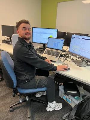 Modern apprentice working at a laptop